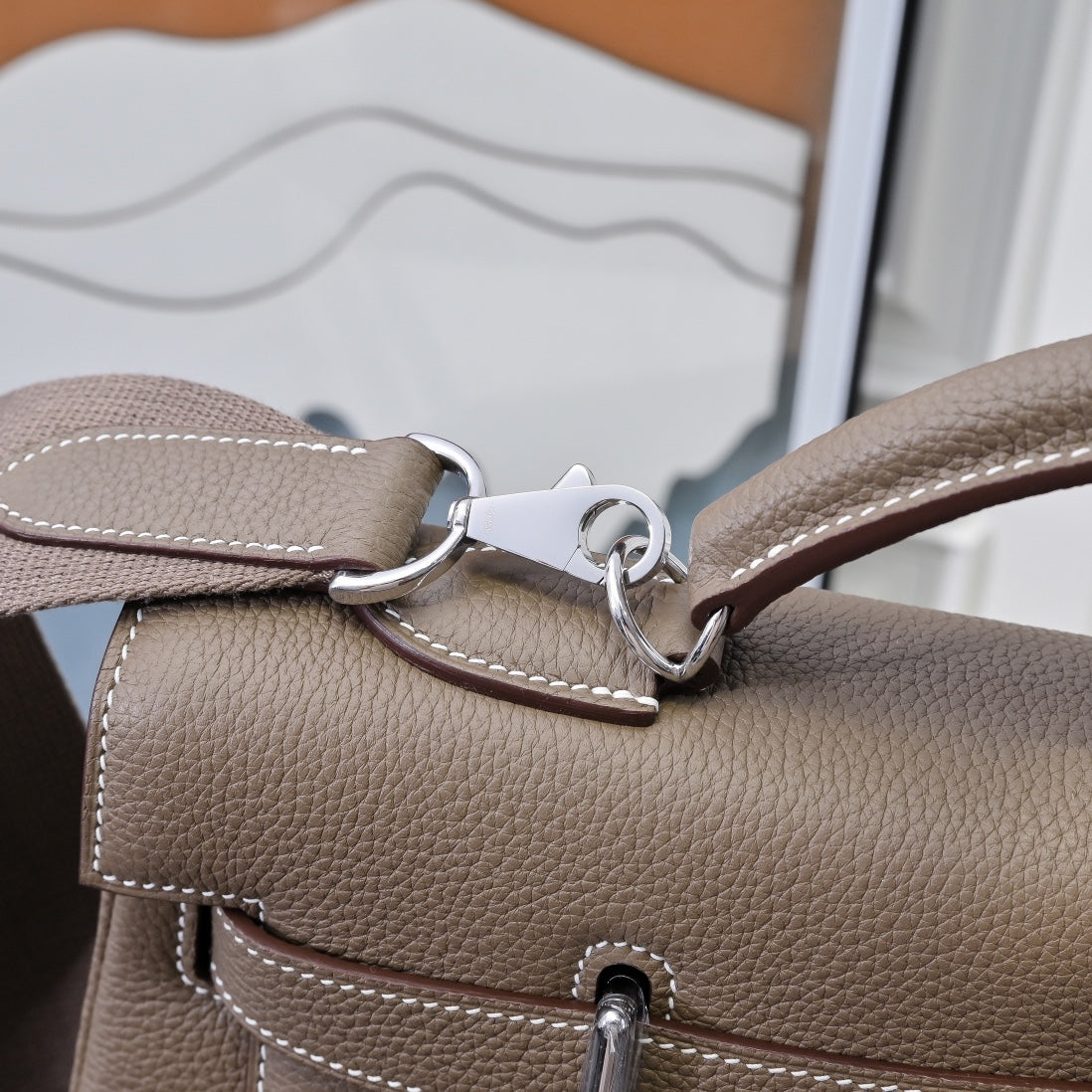 Hermes handbag taupe leather, close-up of strap hardware with D-rings and stitching