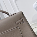 Hermes handbag taupe textured leather, close-up of flap pocket and stitched detail
