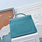 Turquoise leather handbag with front flap pocket and structured rectangular shape