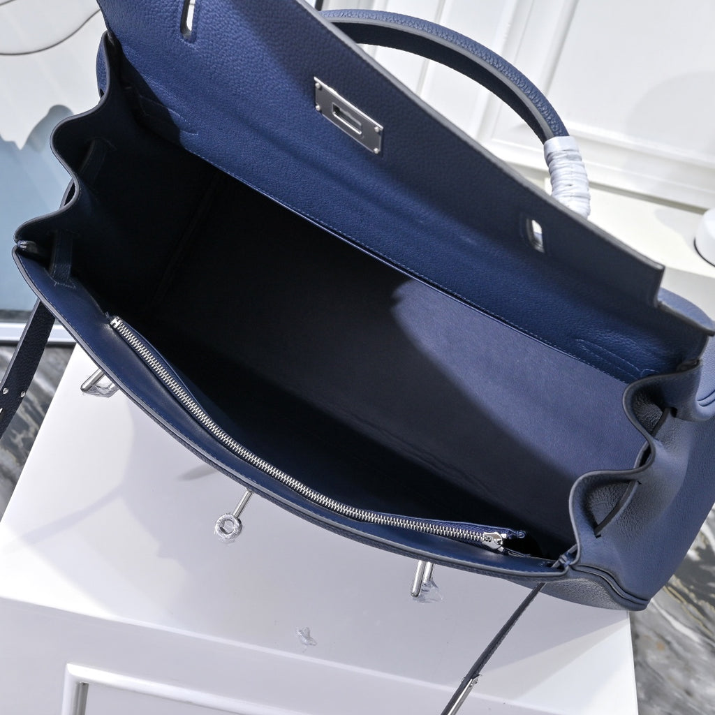 Hermes bag interior view with dark lining and zippered pocket compartment