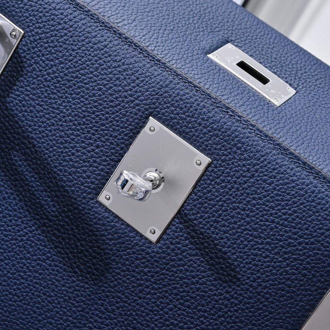 Hermes bag dark blue leather with front flap turn-lock and shiny metal square plates