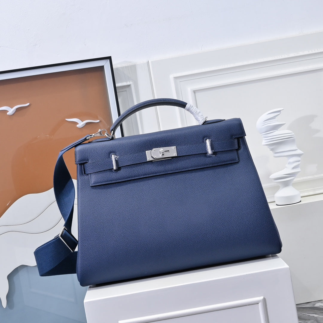 Hermes bag in dark blue leather with top handle and front flap lock detail