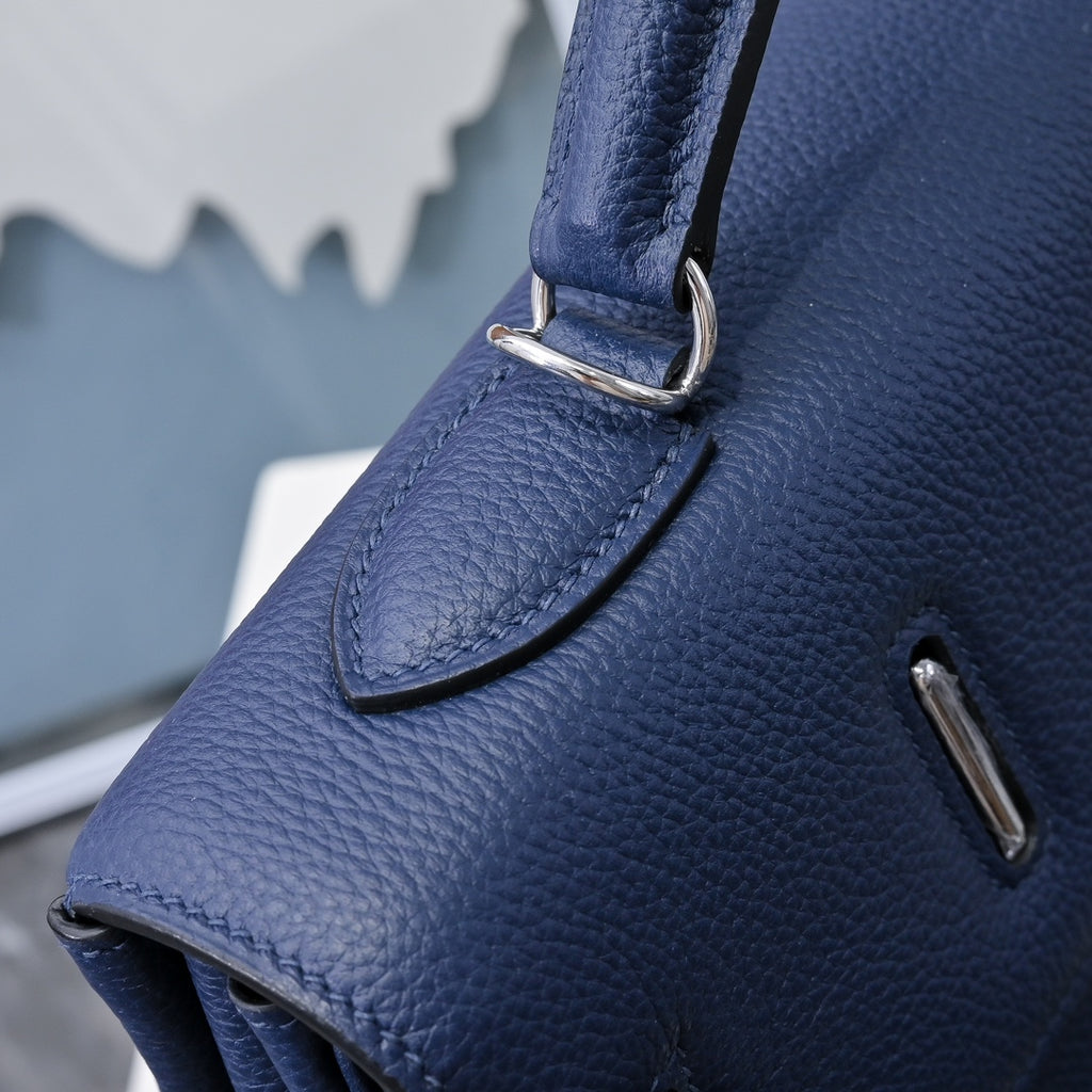 Hermes bag dark blue leather corner with metal strap ring and textured grain