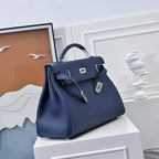 Hermes bag in dark blue leather with front flap, turn-lock closure, and handle