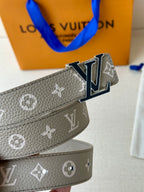 Gray textured monogram belt with LV buckle, showing strap width