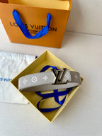 Gray monogram belt in box with LV buckle and blue tie accent