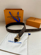 Brown monogram belt with silver LV buckle and blue ties on white dust bag.