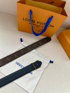 Dark navy leather belt strap with metal buckle, shown with dust bags and ties.