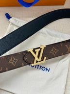 Louis Vuitton belt with dark monogram canvas strap and gold LV buckle closeup