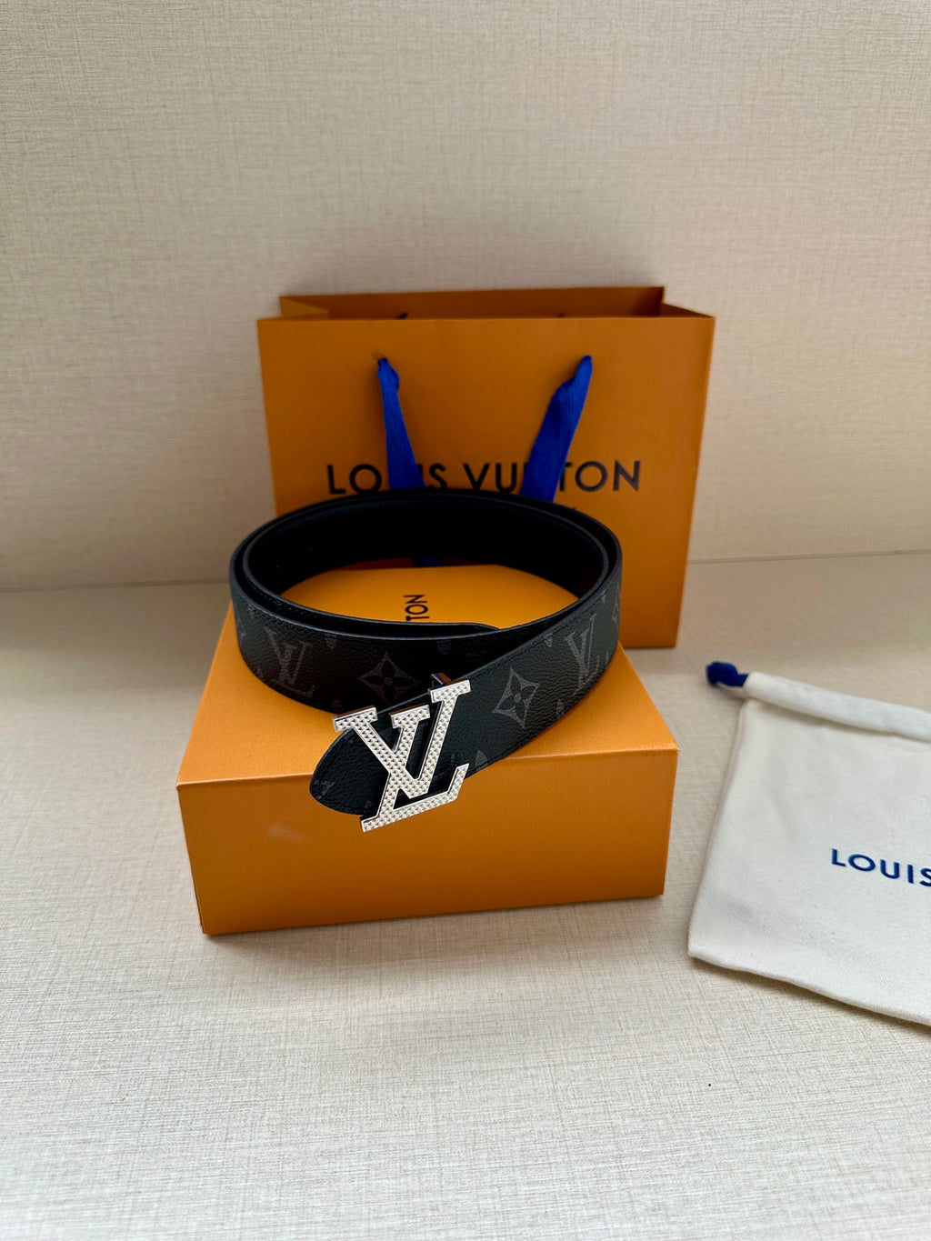 Louis Vuitton monogram belt, dark strap with gold-tone LV buckle and keeper