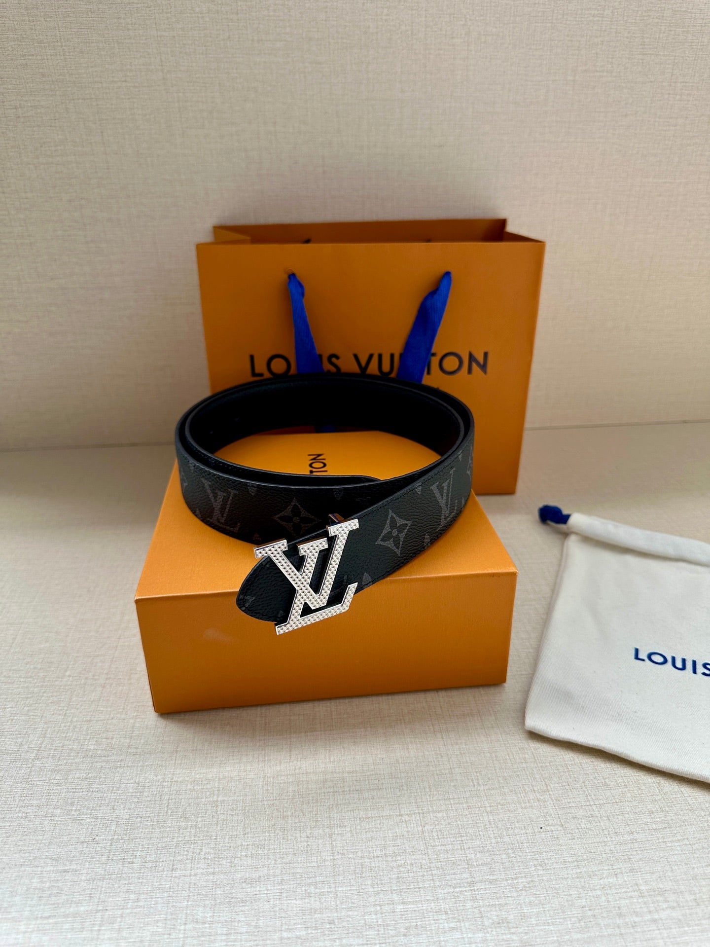 Louis Vuitton monogram belt, dark strap with gold-tone LV buckle and keeper