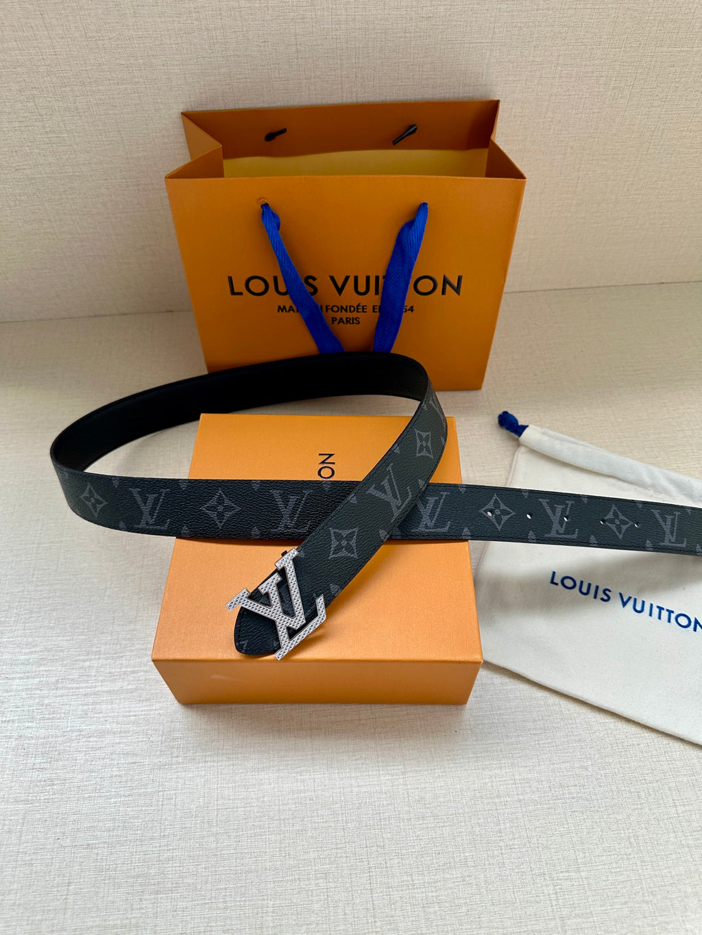Louis Vuitton belt, dark monogram strap with large gold-tone LV buckle