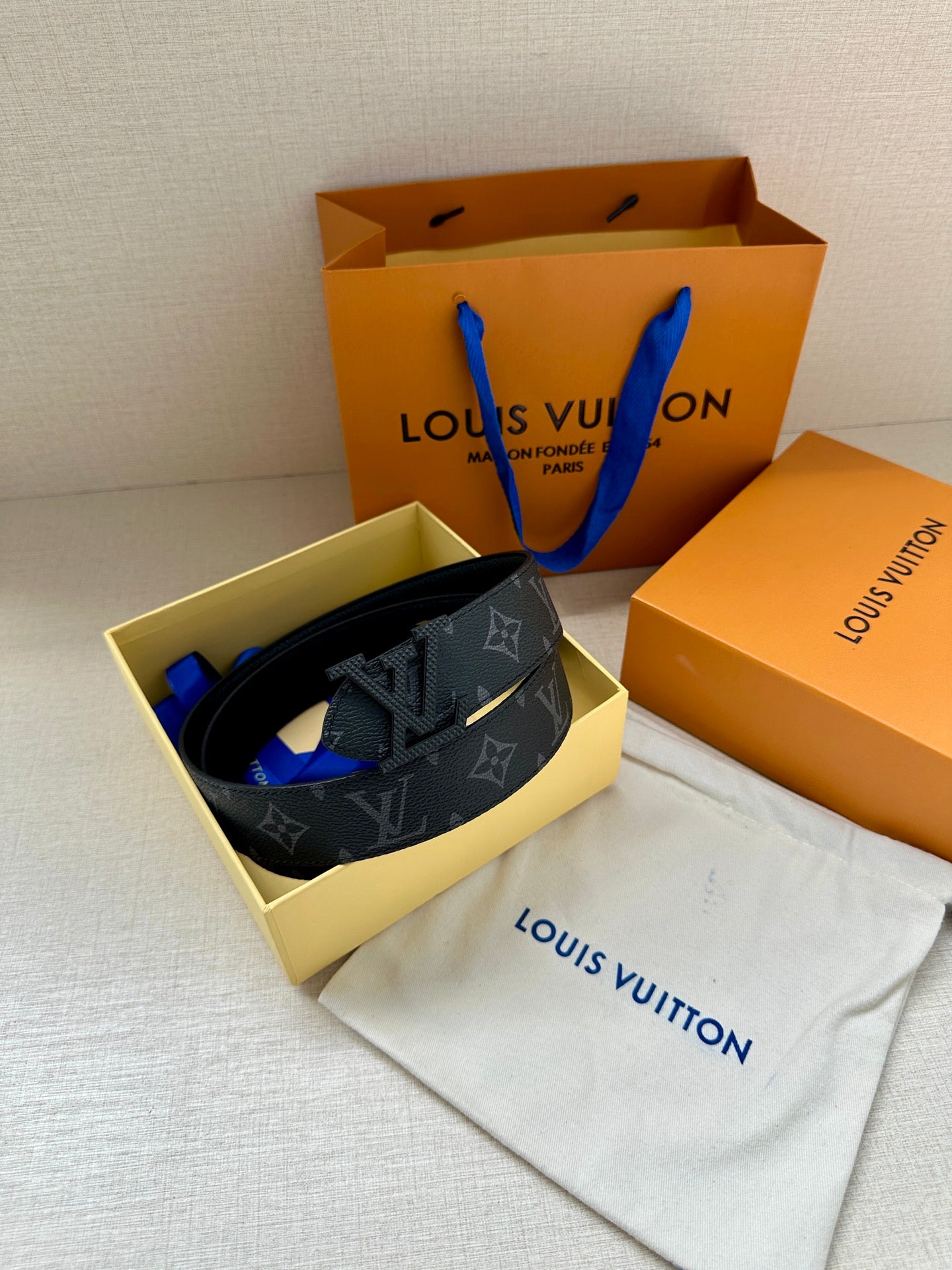 Louis Vuitton monogram belt, dark strap with gold-tone LV buckle and strap end