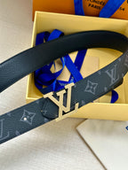 Louis Vuitton belt close-up: dark monogram strap with gold-tone LV buckle