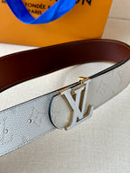 White monogram belt buckle with gold-tone LV emblem and brown leather strap