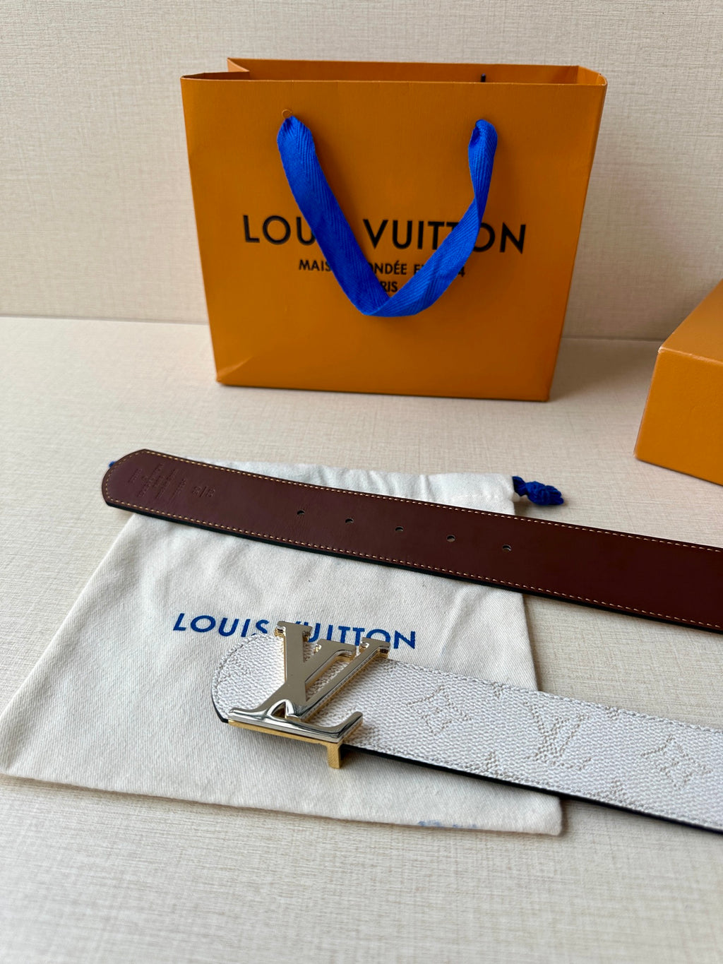 Reversible belt with dark brown leather and white monogram strap, LV gold buckle