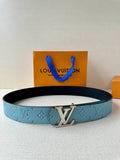 Louis Vuitton belt in blue monogram canvas with gold-tone LV buckle and black edge.