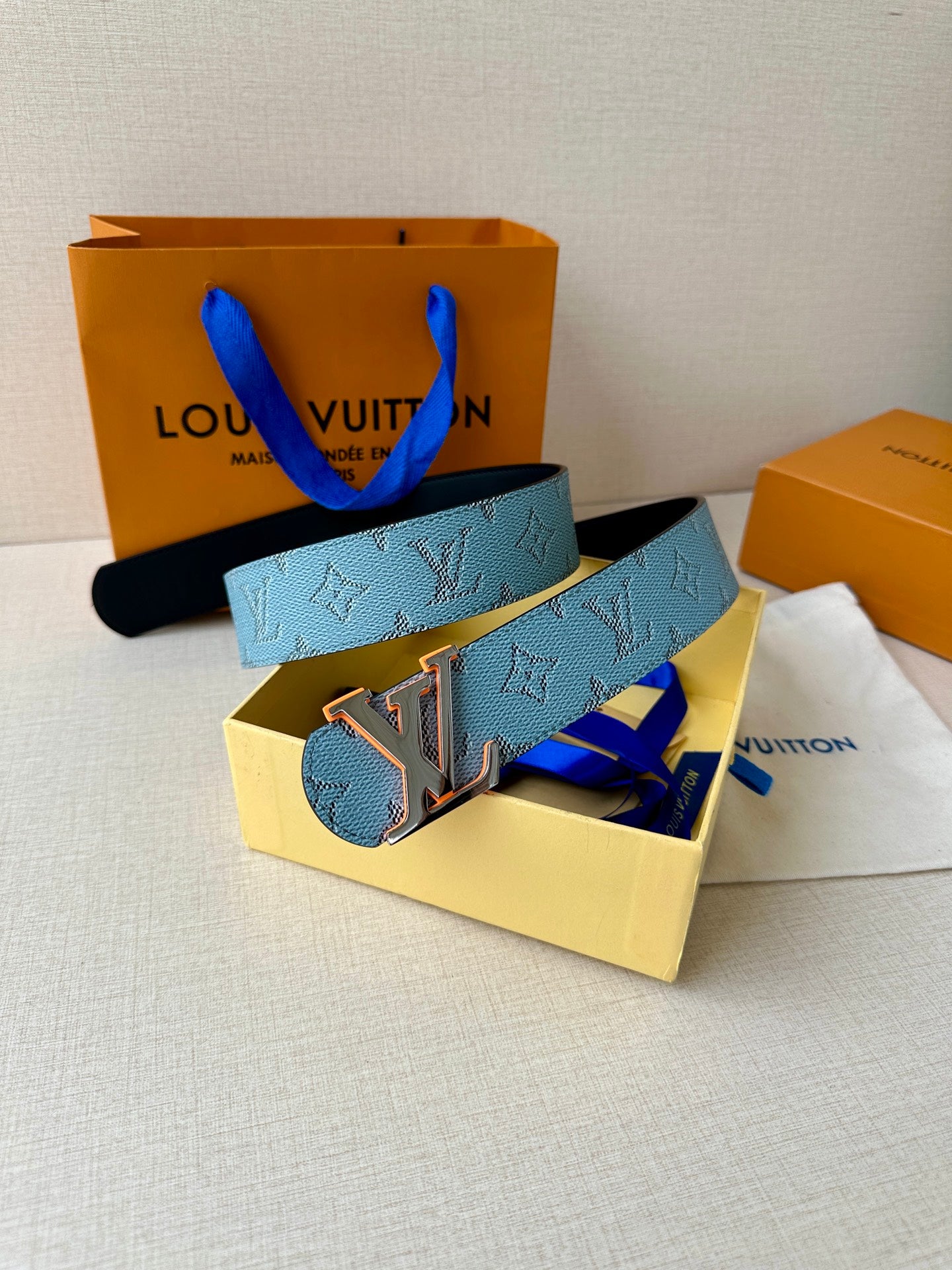 Light blue monogram belt with LV logo buckle and dark backstrap