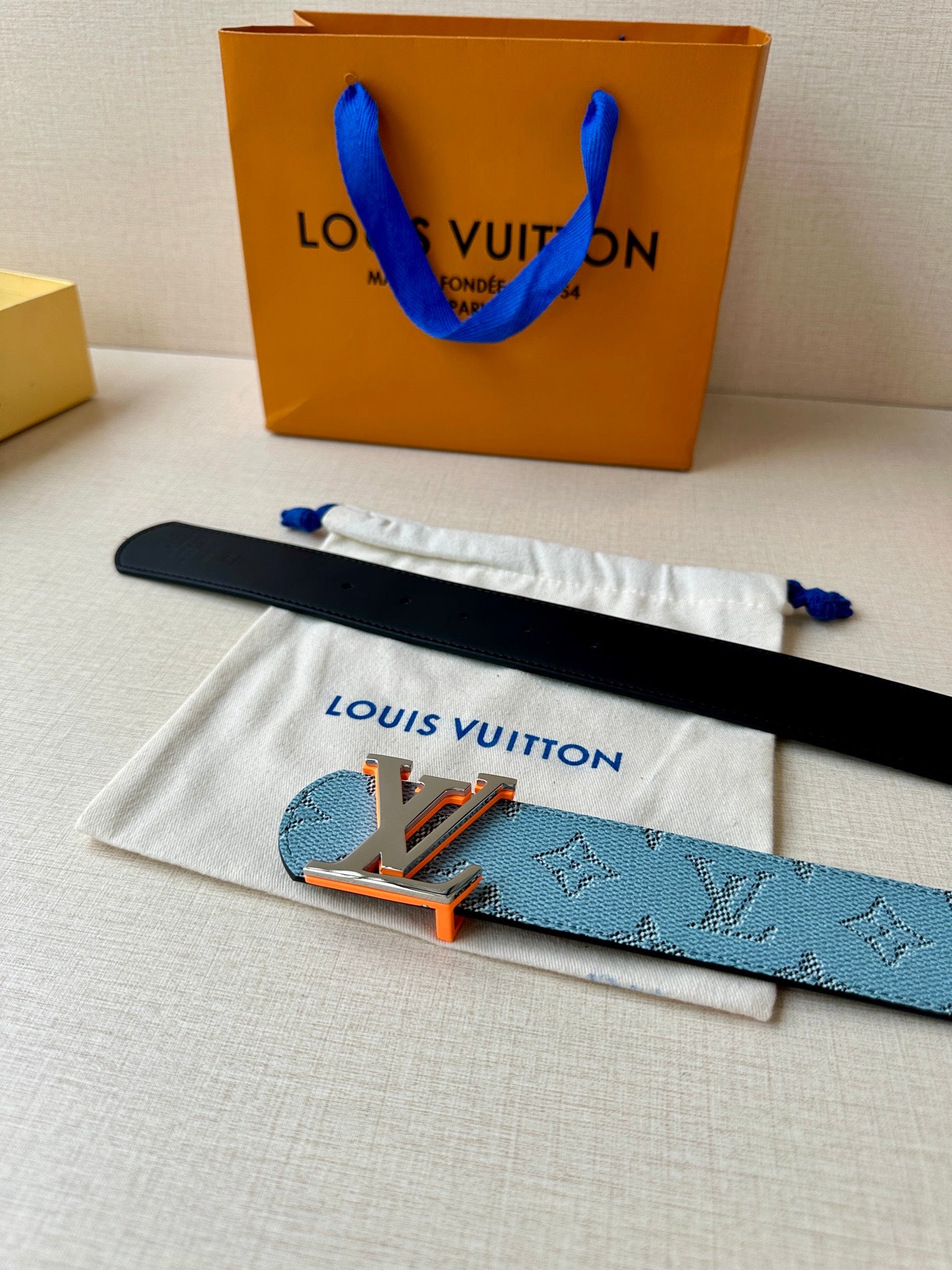 Light blue monogram belt with LV logo buckle on dust cloth