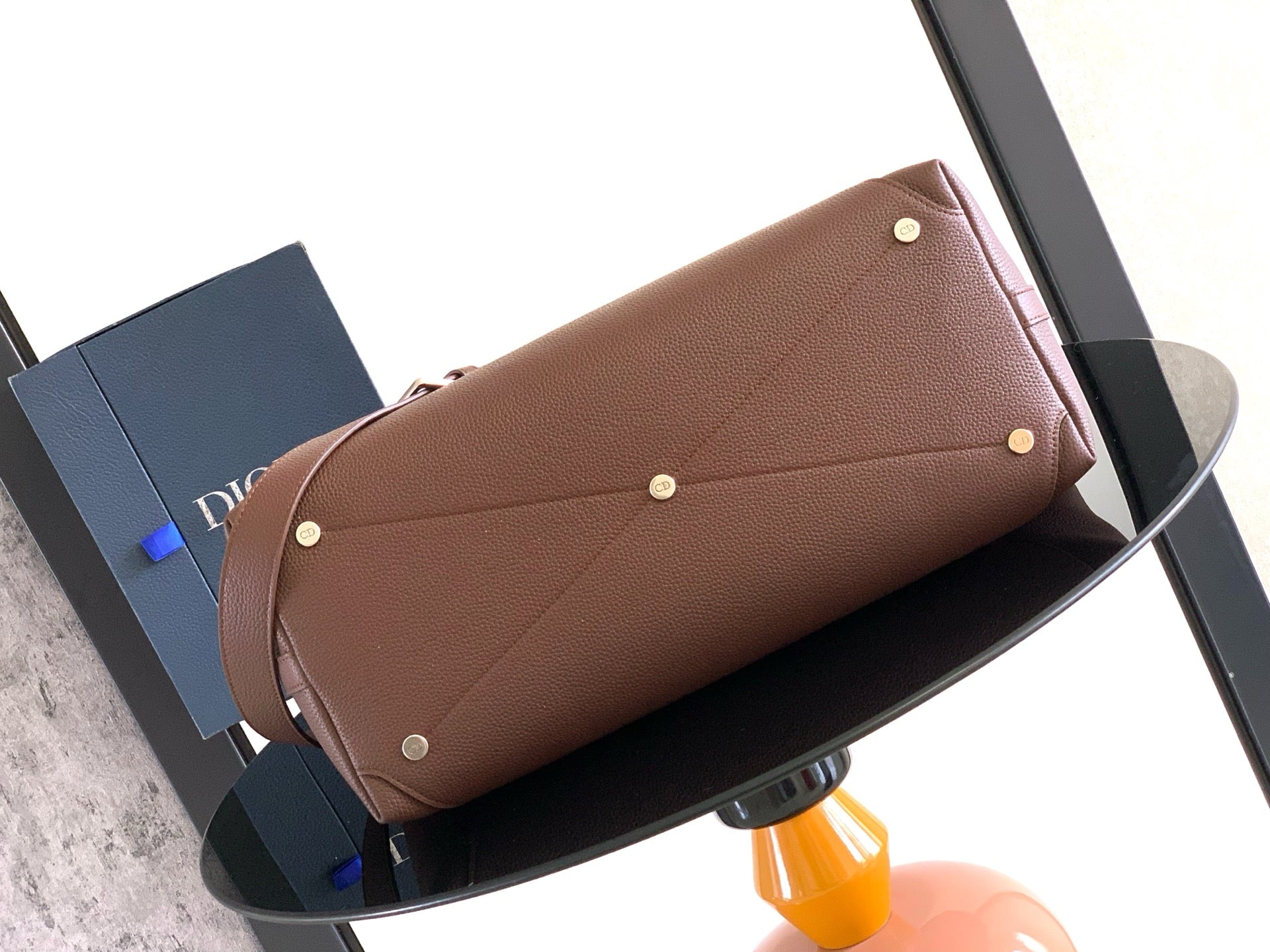 Brown leather pouch with stud snaps and short side handle