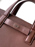 Brown textured leather bag with Dior logo on front pocket