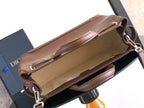 Dior men's brown leather shoulder bag open, showing light interior and zip top