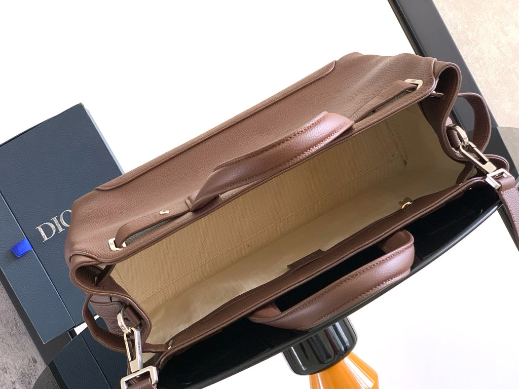 Open brown leather bag with beige interior lining and side pocket