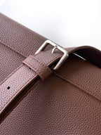 Brown leather bag with stitched strap and silver buckle