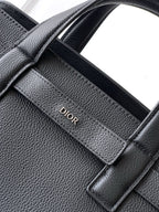 Dior men’s dark leather tote interior panel with Dior embossed logo