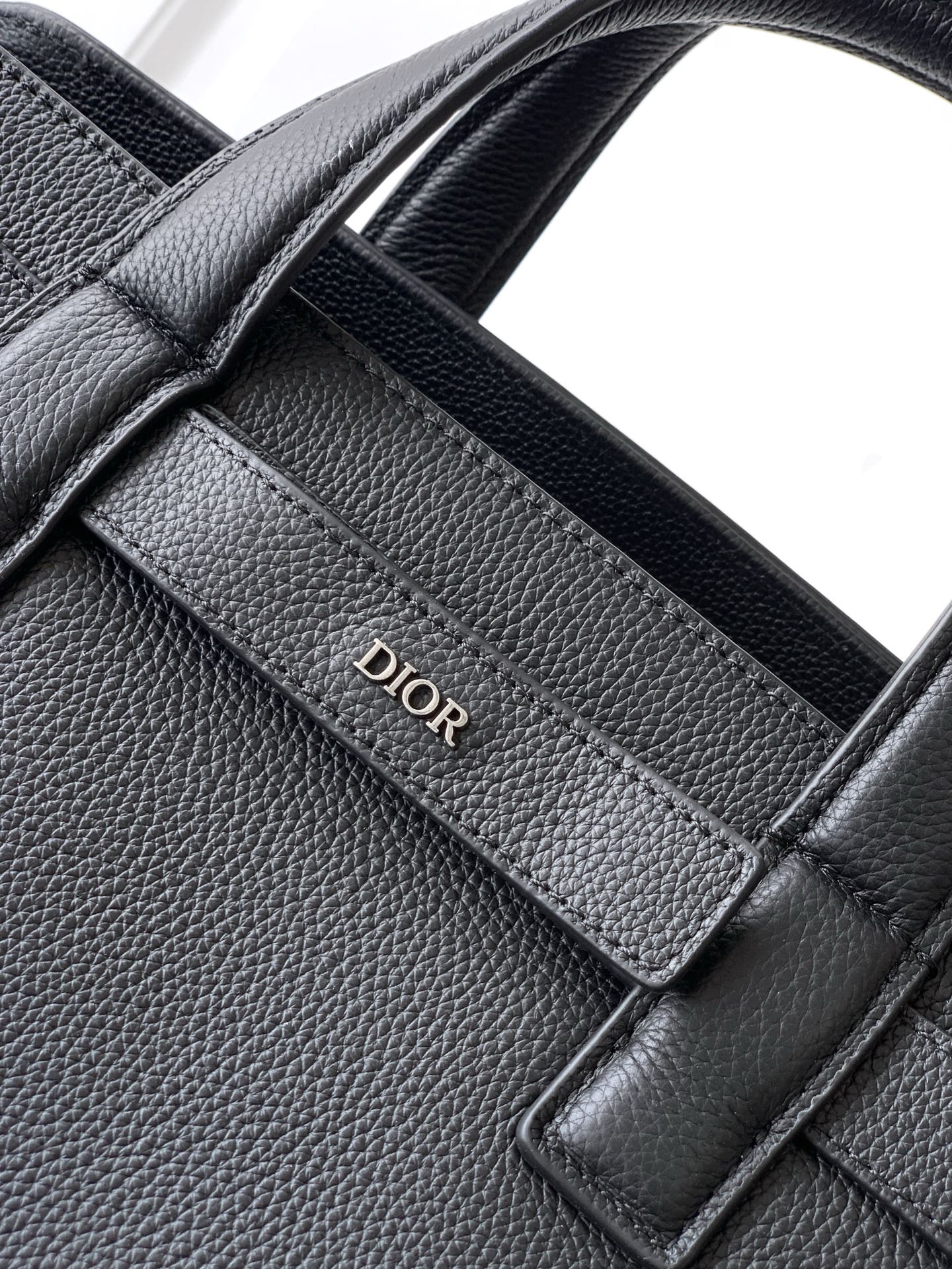 Dior men’s dark leather tote interior panel with Dior embossed logo