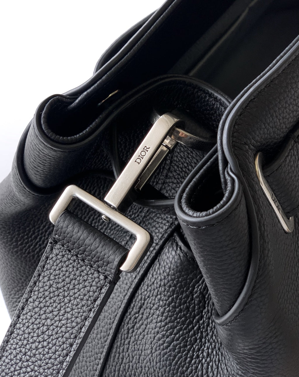 Black leather strap hardware with silver D buckle and stitched strap edges