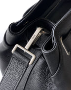 Black leather strap hardware with silver D buckle and stitched strap edges