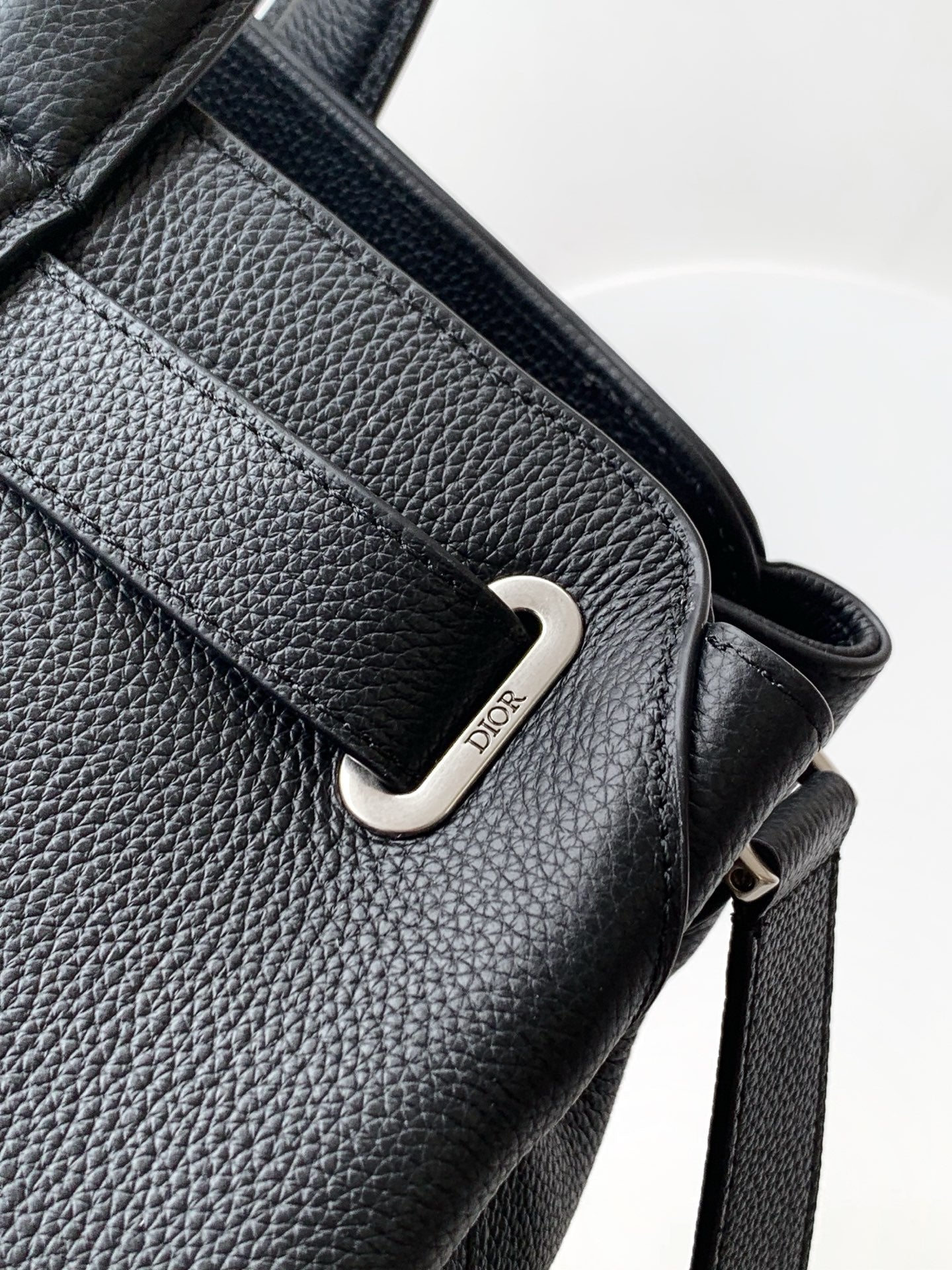 Dior men’s dark leather tote strap with metal buckle and Dior tag