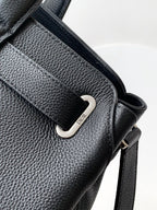 Black leather shoulder strap with silver D-ring buckle and branded snap tab