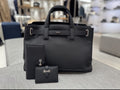 Dior structured tote with top handles, front logo, and small matching pouch