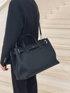 Dior structured tote with top handles, front logo, and detachable shoulder strap