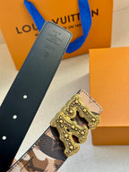 Designer belt with dark leather strap and camo panel, featuring ornate gold buckle