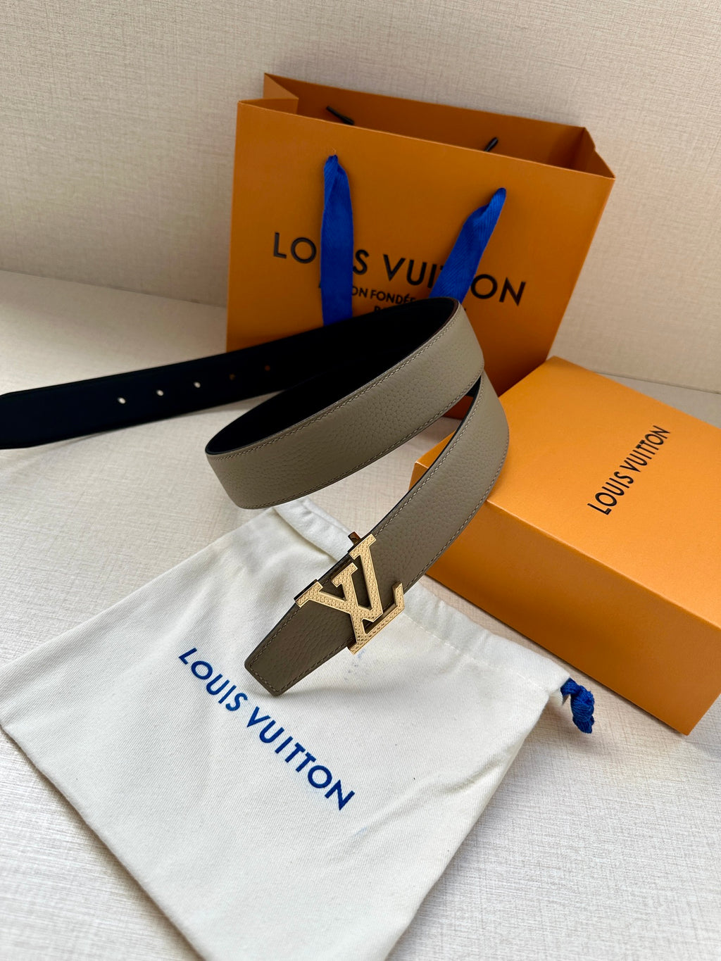 Louis Vuitton reversible belt with dark and beige straps and gold LV buckle