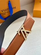 Leather belt, brown textured strap with silver LV buckle on dark back.