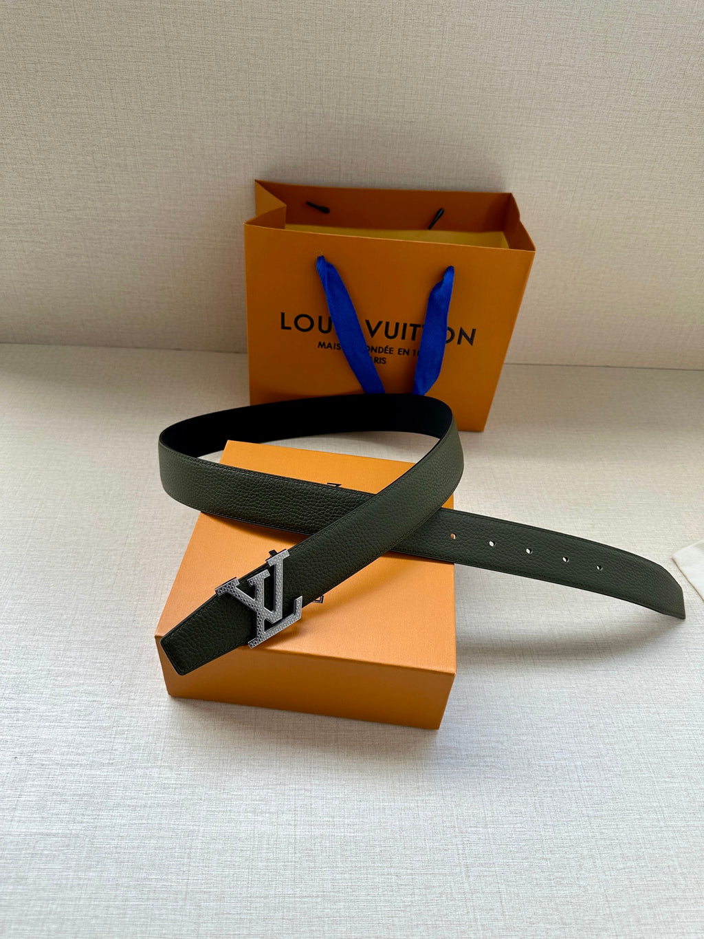 Dark green leather belt with gold LV buckle and belt holes