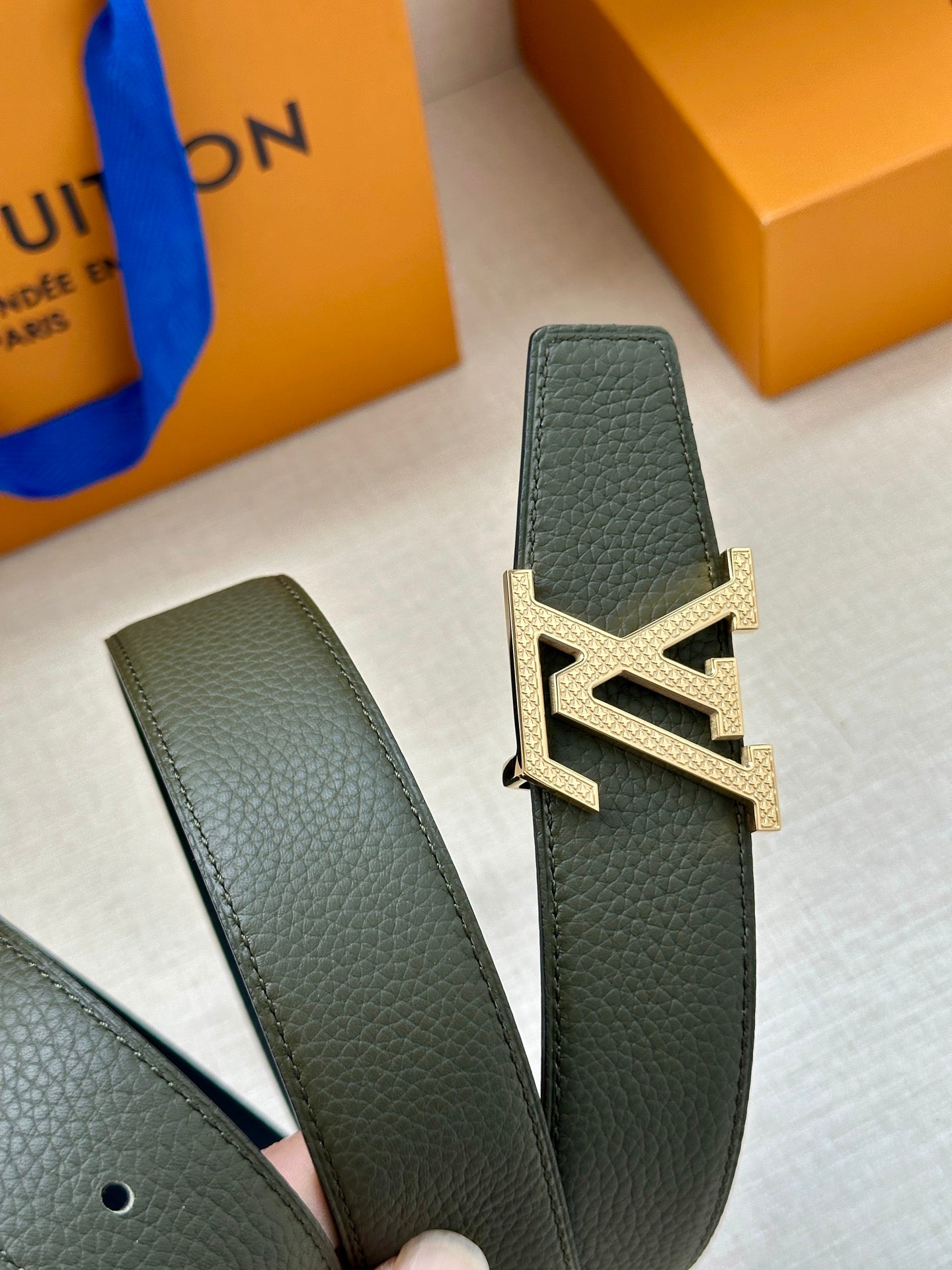Dark green leather belt strap with gold interlocking LV buckle