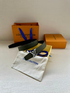 Dark green belt with gold LV buckle, coiled with strap details