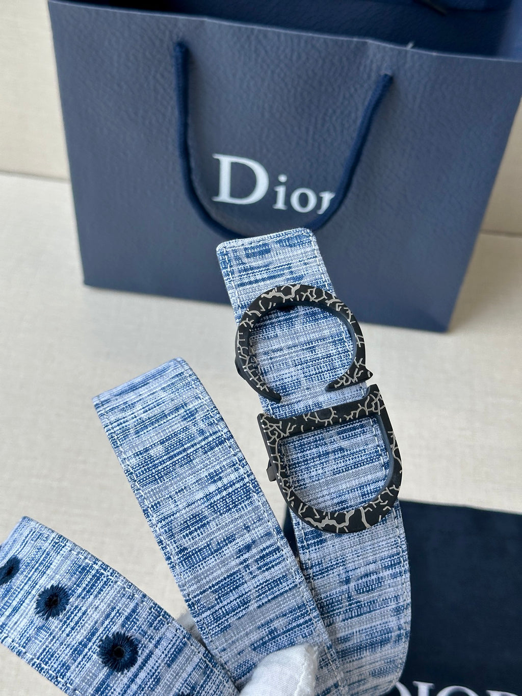 Dior belt with blue patterned strap and ornate double oval buckle detail