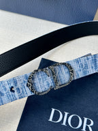 Dior belt close-up with textured blue strap and double circular buckle