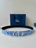 Blue fabric belt with silver-tone CD buckle and perforated strap holes.