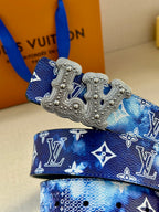 Louis Vuitton belt detail: blue monogram strap with large silver-tone ornate buckle.