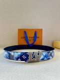 Louis Vuitton belt in blue monogram print with gold-tone ornate buckle detail.