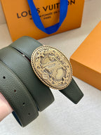 Dark green leather belt with textured surface and gold-toned oval logo buckle.