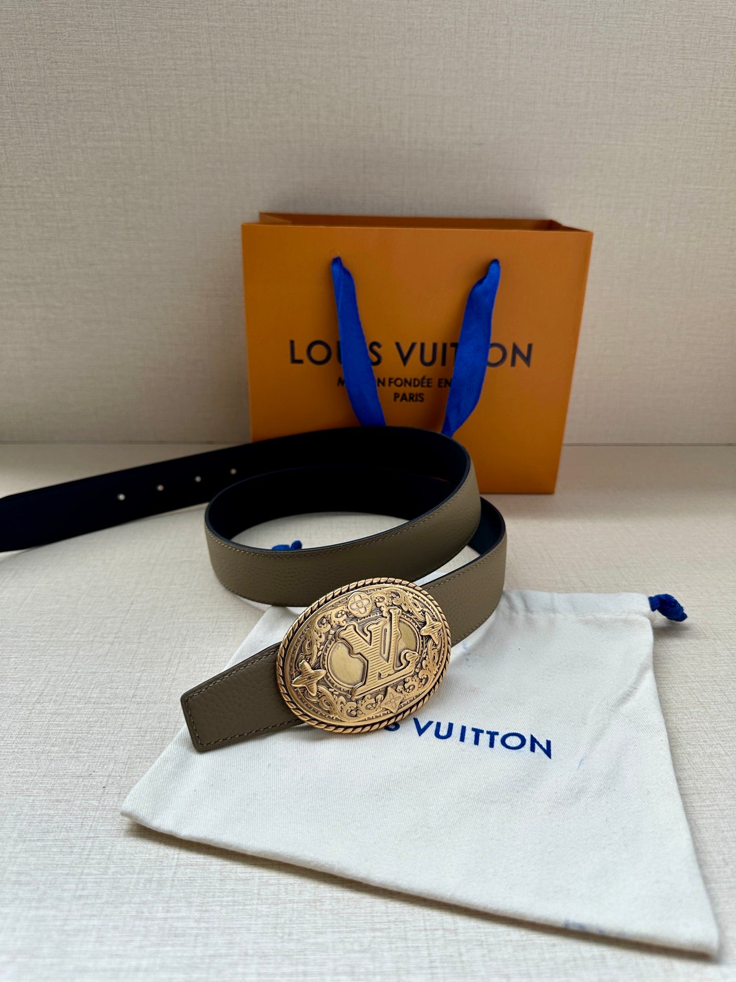 Louis Vuitton belt on pouch, beige strap with large oval gold emblem buckle