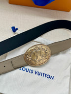 Louis Vuitton belt close-up, beige strap with oval emblem buckle